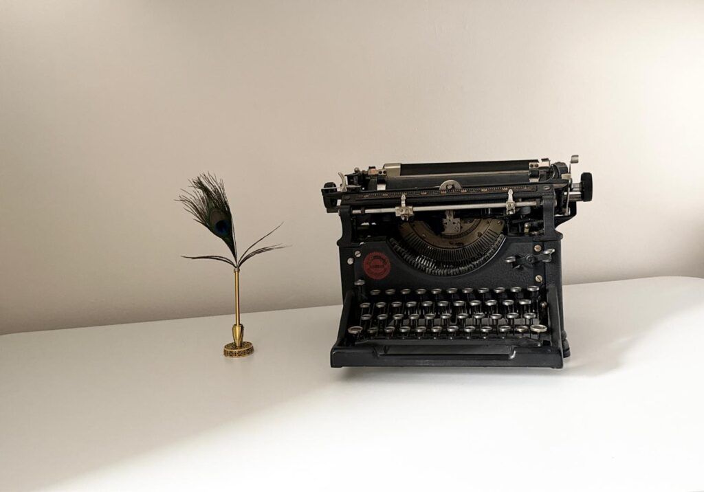 Vintage typewriter and quill representing Peacock Pen Press publishing